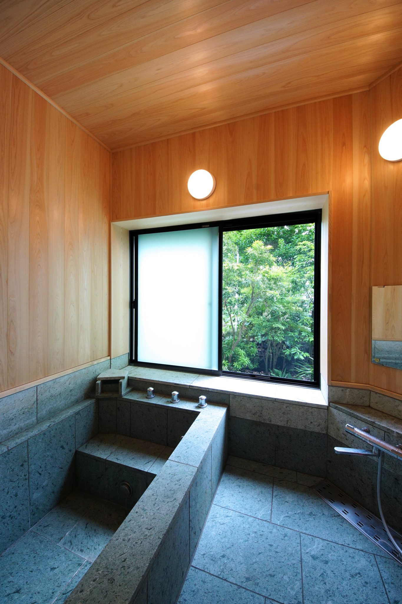 石張りの温泉浴室は旅館のような風情